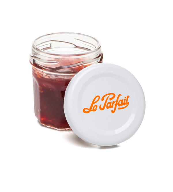 Le Parfait 44 ml Mini Confiture jar filled with fruit preserves beside its orange twist lid